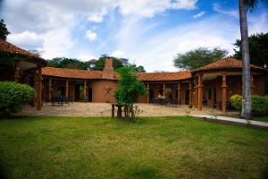 a house with a courtyard with tables and chairs at Raha Wildlife Resort in Arusha