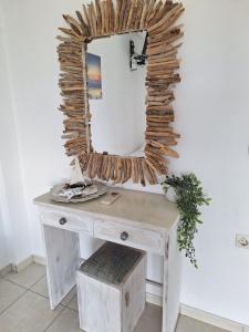 a dressing table with a mirror on a wall at Horizon studio apartment in Palaiokatoúna +73 photos