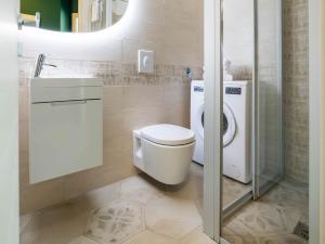 a bathroom with a toilet and a sink and a shower at Serenity with swimming pool and parking in Alassio in Alassio +18 photos