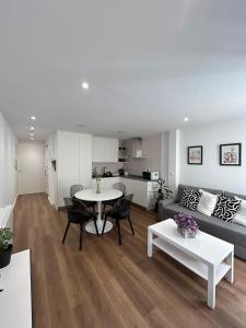 a living room with a couch and a table at Adiva Suite in Puentedeume +28 photos