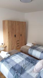 a bedroom with two beds and a large mattress at Apartman Basarac in Gračac