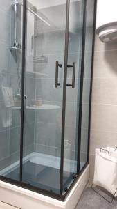 a glass shower in a bathroom with a sink at Apartman Basarac in Gračac +10 photos