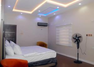 una camera da letto con un letto con un ventilatore e un soffitto di LaSem Haven a Ijebu Ode