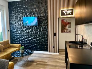 a kitchen and living room with a couch and a table at Aura Apartment und Spa Oberhausen in Oberhausen +7 photos