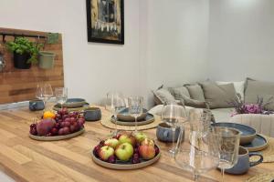 a table with three plates of fruit on it at Mala Lu Central Apartment in Varaždin +18 photos