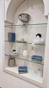 a glass shelf with items on it in a room at Mala Lu Central Apartment in Varaždin