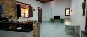 a living room with a counter and a couch in a room at Sítio Wida Feliz in Crato