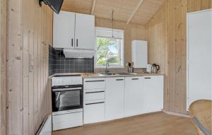 a kitchen with white cabinets and a window at 2 Bedroom Gorgeous Home In Humble in Humble