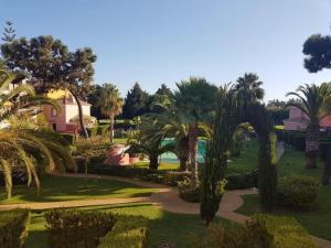 an aerial view of a park with palm trees at Bonita casa adosada in Islantilla