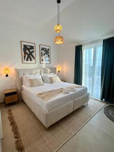 a large white bed in a room with a large window at Casa Katarina in Novalja +33 photos