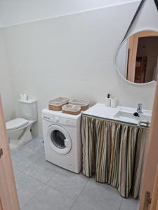 a bathroom with a washing machine and a sink at Apto Islote in Arrecife