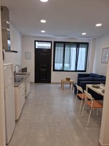 a kitchen and living room with a couch and a table at Apto Islote in Arrecife