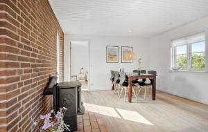 a living room with a brick wall and a table at 3 Bedroom Lovely Home In Millinge in Millinge