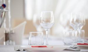 three wine glasses sitting on top of a table at Mihai Palace in Buftea