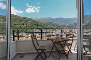 a table and chairs on a balcony with a view at Toplish 3 relax in Budva