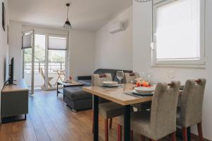 a dining room and living room with a table and chairs at Toplish 3 relax in Budva