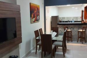 a dining room and kitchen with a glass table and chairs at Casa do Cristiano no bairro Rosário in Ouro Preto