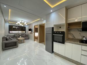 a kitchen and living room with a stove at appartment igar azougagh elhoceima in Al Hoceïma