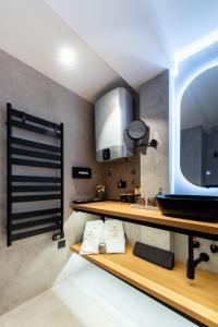 a kitchen with wooden shelves and a sink at FREJA- Luxury Studio apartment Old town Zadar Center in Zadar