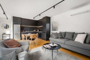 a living room with a couch and a table at Nestled below the Remarkables in Queenstown