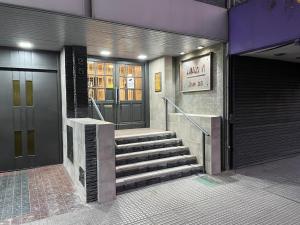 a staircase leading to a building with a revolving door at Mendoza Centro in Mendoza