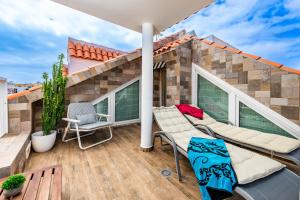 a balcony with a patio furniture and a house at Calas Beach Corralejo in Corralejo