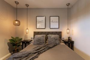 a bedroom with a large bed with three pictures on the wall at Holyhome cucharas beach in Costa Teguise +15 photos