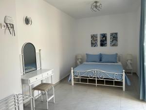 a bedroom with a bed and a dresser and a mirror at Antiparos Diamond in Antiparos