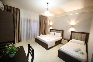 Postel nebo postele na pokoji v ubytování Hotel Erjuma