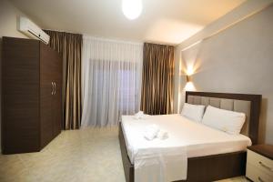 Postel nebo postele na pokoji v ubytování Hotel Erjuma