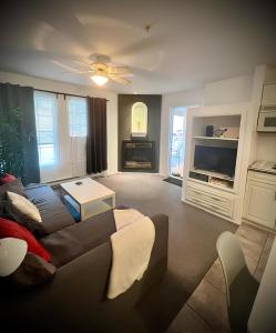 a living room with a couch and a tv at Modern Dream at Fairmont in Fairmont Hot Springs