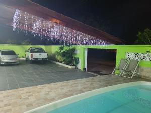 a garage with a car parked in it at night at Unidades 1 e 2 e 3 Pousada do Sossego Mar e Verde in Itanhaém