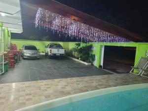 a parking lot with cars parked in a garage with lights at Unidades 1 e 2 e 3 Pousada do Sossego Mar e Verde in Itanhaém