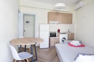 a small apartment with a table and a kitchen at Theo Apartment Rethymno in Rethymno +17 photos