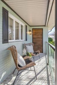 a porch with wicker chairs and a door at Point Break in Ocean City