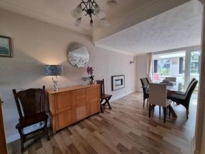 a living room with a table and a dining room at Charming coastal bungalow in Cayton