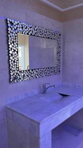 a bathroom with a large sink and a mirror at Residence wassim in Ras El Ma +42 photos