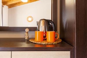 two coffee mugs sitting on a counter in a kitchen at Potam'Sea Bliss 35- Beach Front, Sun Beds & Parking in Himare