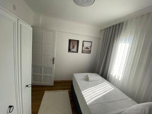 a small bedroom with a bed and a window at Villa Deja Blue in Karaburun