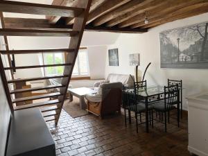 a living room with a table and chairs at Appartement tout confort en centre-ville in Cosne Cours sur Loire