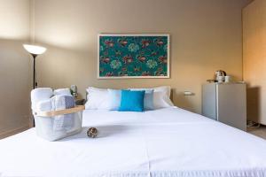 a bedroom with a large white bed with towels on it at Color Villa - South Paradise 2 in Himare +18 photos