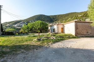 a small house on the side of a dirt road at Color Villa - South Paradise 2 in Himare