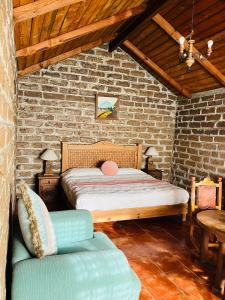 a bedroom with a bed and a brick wall at Cabañas Los Cactus in San Miguel Regla +33 photos