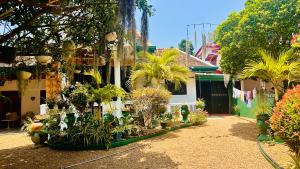 a house with a lot of plants in front of it at Shehan villa in Beruwala