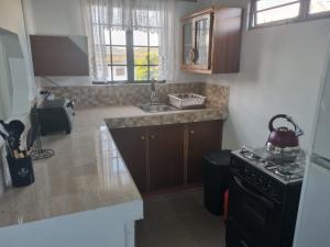 a kitchen with a black stove and a sink at Breeze Manor in Scarborough