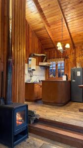 a kitchen with a stove in the middle of a room at Cabaña en Villa Los Leones in Pinto
