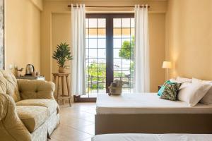 a living room with a couch and a large window at Color Villa - South Paradise 6 in Himare