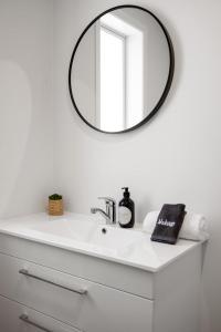 a bathroom with a sink and a mirror at Idyllic family escape, Close to the beach and Mount in Mount Maunganui +24 photos