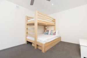 a bedroom with a bunk bed in a room at Sunny and Spacious - moments from the Beach and Downtown in Mount Maunganui +24 photos
