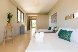 a large room with two beds and a bathroom at Color Villa - South Paradise 7 in Himare